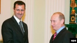 Russian President Vladimir Putin's reported buildup in Syria may be a move to maintain a foothold in that country -- and try to secure a strong say in what comes next -- in the event that President Bashar al-Assad (seen here with Putin in 2006) is ousted.