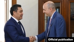 RFE/RL President Jamie Fly (right) meets Kyrgyz President Sadyr Japarov in Bishkek in September 2021.