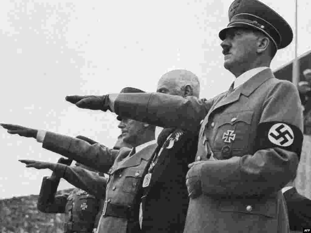 German Chancellor Adolf Hitler gives the Nazi salute during the opening ceremony of the Berlin Olympic Games in 1936.