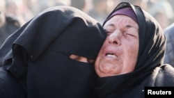 Mourners react near the bodies of Palestinians killed in Israeli air strikes in Khan Younis on January 17. 