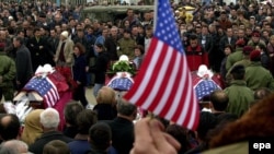 Citizens pay tribute to the bodies of the three Bytyqi brothers in Pristina in February 2002.