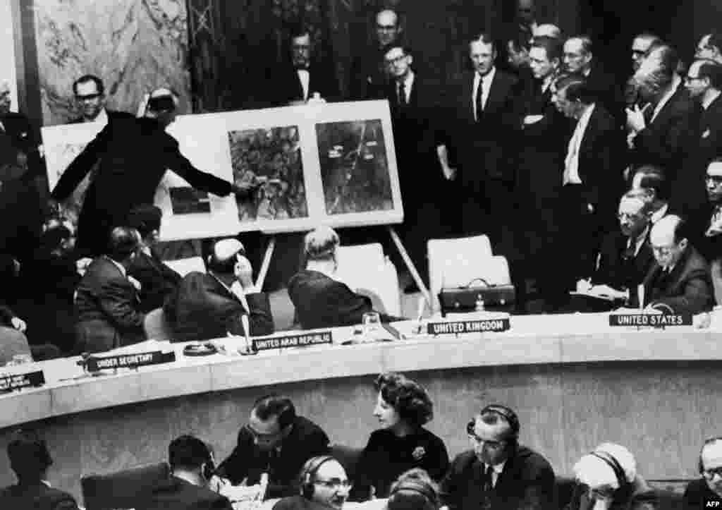 A U.S. administration official shows aerial views of one of the Cuban medium-range missile bases to the members of the UN Security Council on October 26.